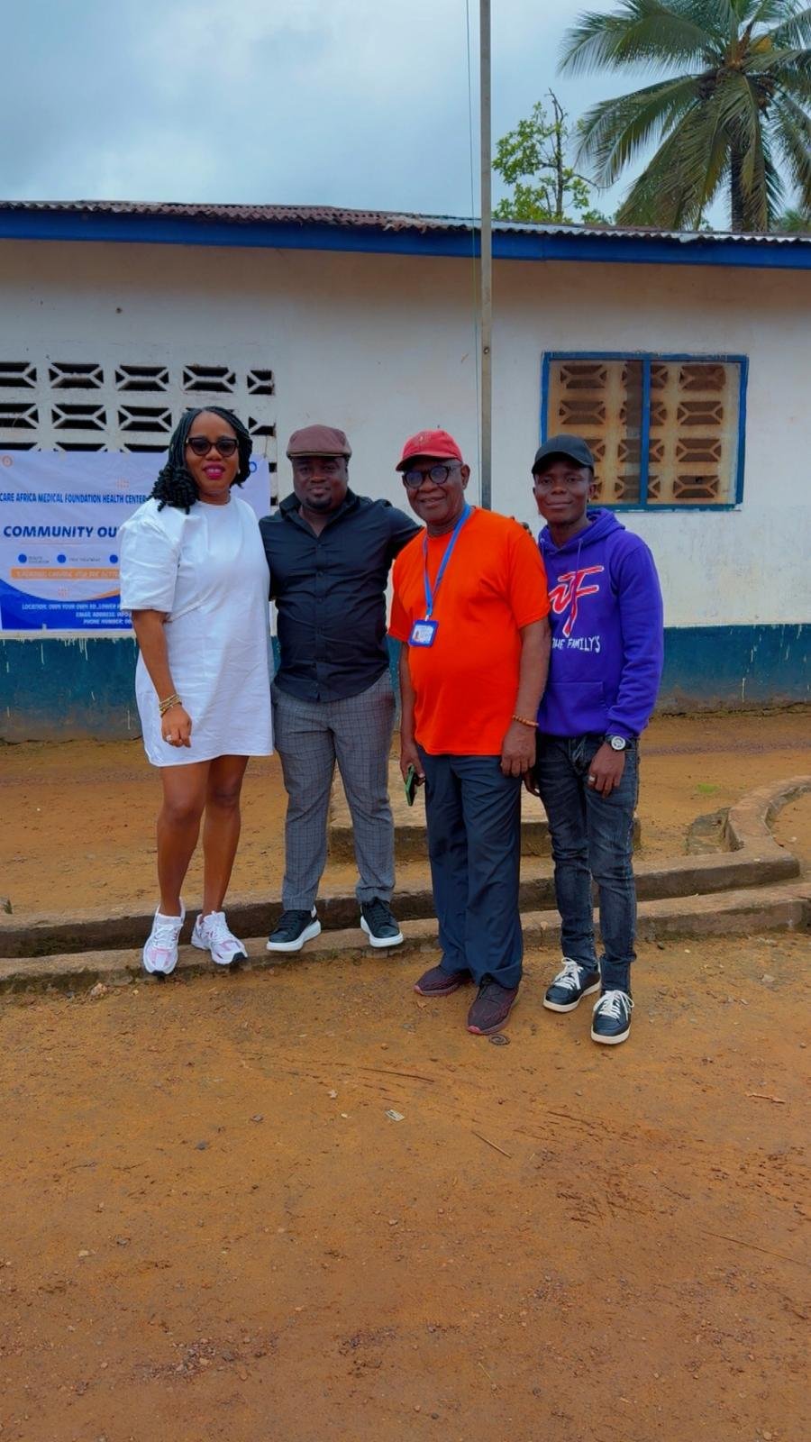CAMF team in front of a community outreach banner