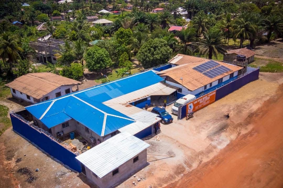 Aerial view of the CAMF medical center with solar panels on the roof